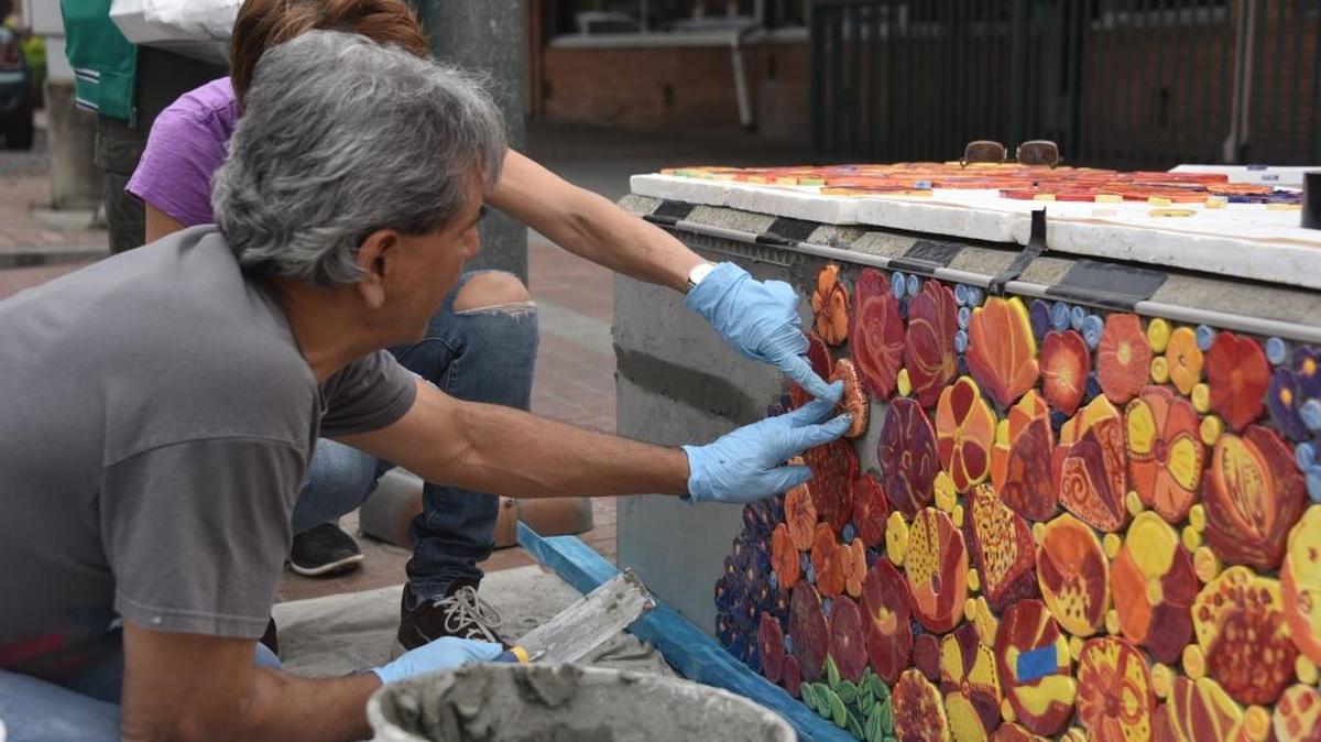 Monika Modest, 61, and Ed Contreras, 56, are using cement to place poppies on the flag pole base in Bob Hart Square on Sunday, March 19, 2017. The poppy’s were glazed and painted by community members. Each poppy is $5 and the proceeds go toward the Valley Crisis Center and the Merced County Rescue Mission.