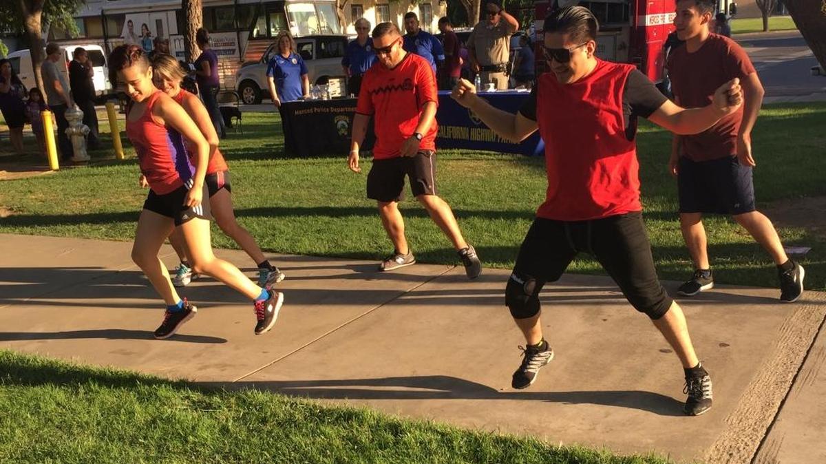 Community members join in on Zumba dancing at the block party commemorating National Health Center Week at Golden Valley Health Center in Merced on Friday, Aug. 12, 2016.