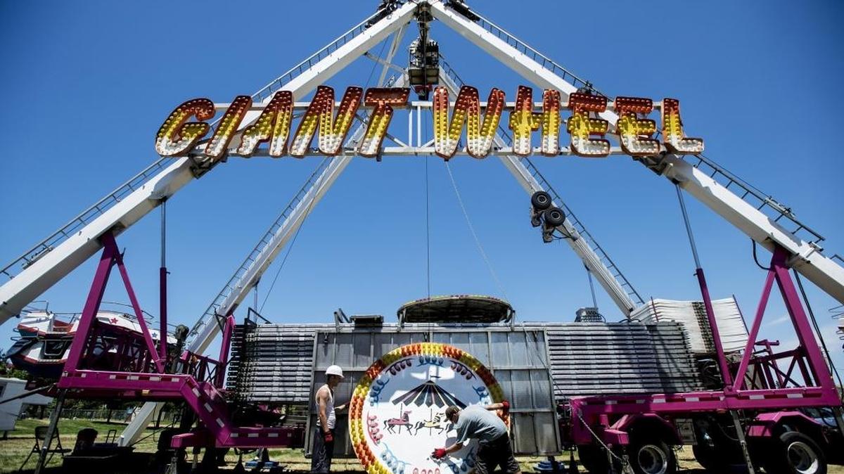 Workers construct a Ferris wheel as crews prepare for the Livingston Fourth of July Festival at the Max Foster Sports Complex in Livingston, Calif., on Wednesday, June 29, 2016. The festival begins Friday night.
