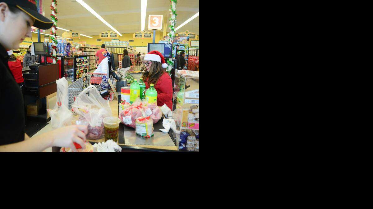 
Maria Franco, right, rings up a customer while Jessica Ramirez bags groceries at Santa Fe Mercado y Carniceria on Thursday morning in Los Banos. The store reopened this month after a fire in January.
