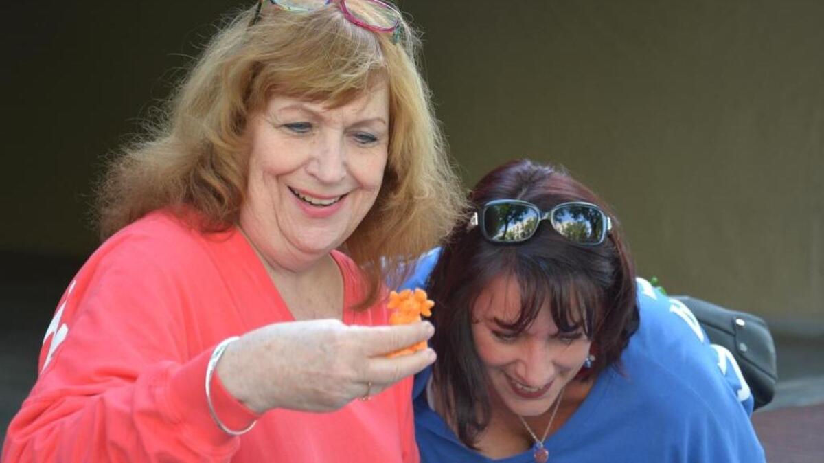 Los Banos resident Diana Thurston checks out a miniature sculpture made by artist Megan Thrasher as Los Banos resident Lara Olson checks out more pieces during the Merced Art Hop Saturday, April 15, 2017, on Main Street in downtown Merced.