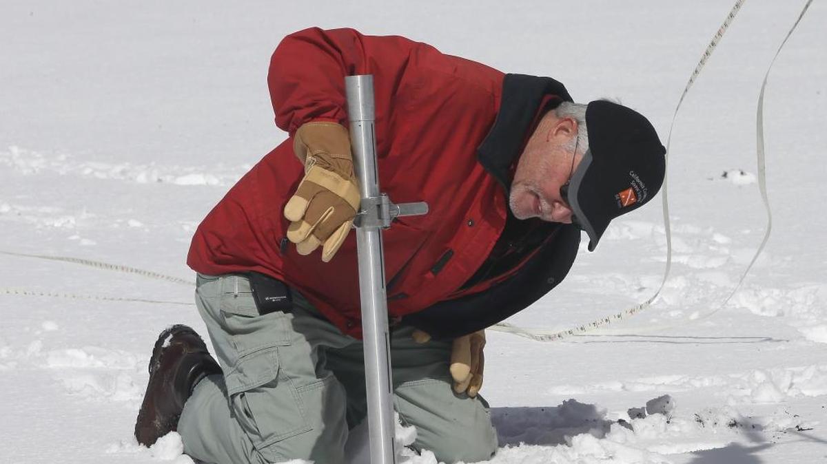 Frank Gehrke, chief of the California Cooperative Snow Surveys Program for the Department of Water Resources, checks the snowpack depth while performing the snow survey at Phillips Station near Echo Summit on Wednesday, March 30, 2016. The survey showed the snowpack at about 95 percent of normal for this site at this time of year.