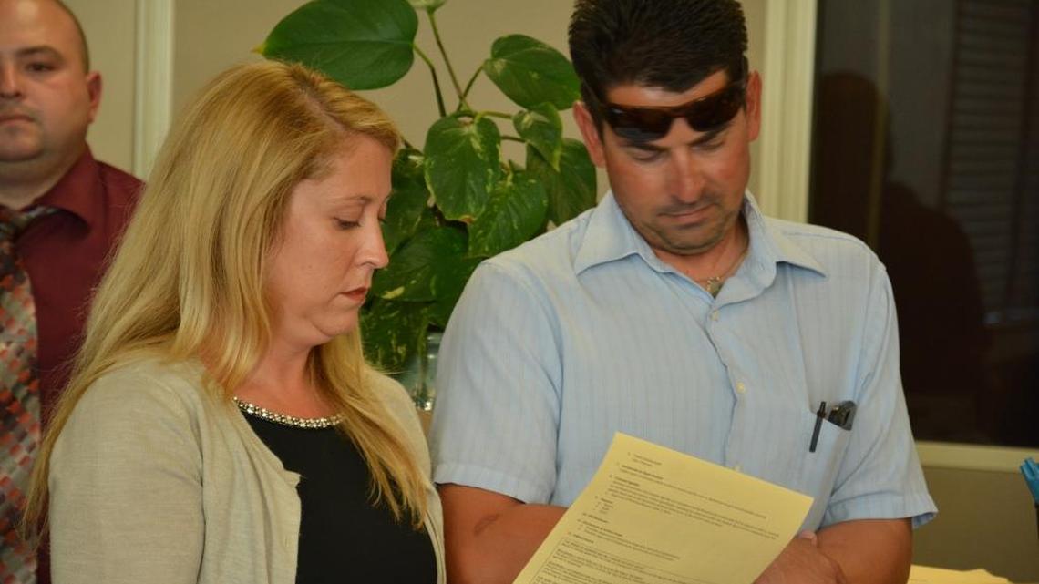 Former Foundations Public Schools CEO Tisha Blackwood-Freitas and husband Matt Freitas look at an agenda during the charter school district's board meeting Tuesday in Los Banos.