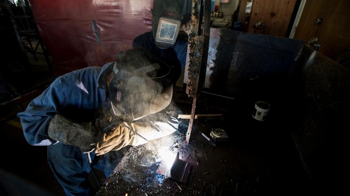 Junior Eric Favela, left, and sophomore Joel Rojas practice welding techniques as part of the FFA program at Atwater High School in February.