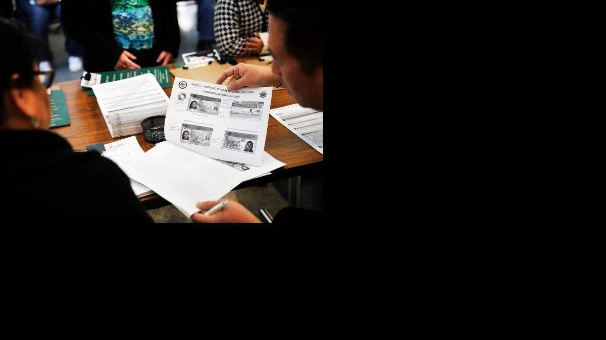 DMV staff help people taking advantage of Assembly Bill 60 to  apply for driver’s licenses in Fresno in January.