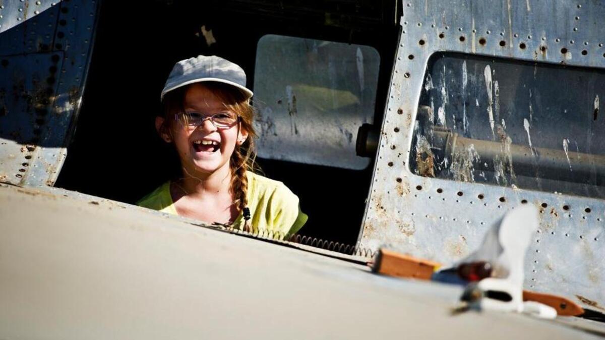 Lilly Infante, 9, of Placerville looks out of a B-23 airplane during Open Cockpit Day at Castle Air Museum in Atwater in 2014. The museum is home to a collection of about 70 historic aircraft, many of which are at risk of being damaged from sitting outdoors.
