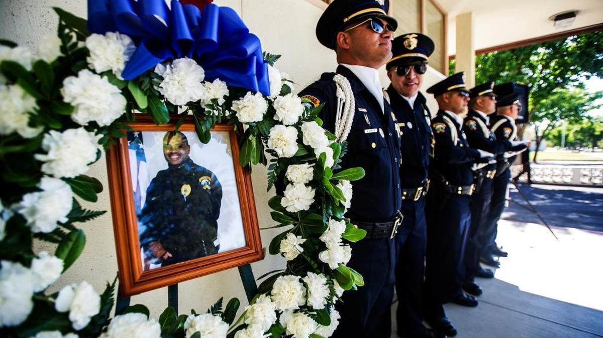 A photograph of Merced police Officer Stephan Gray is displayed during a memorial at the Merced Police Department last year. Gray, 34, was shot and killed in the line of duty April 15, 2004, while chasing a gang member.