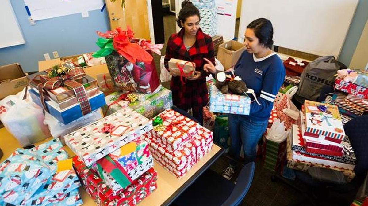 Student interns sort gifts for A Home for the Holidays, an outreach program that supports All Dads Matter.