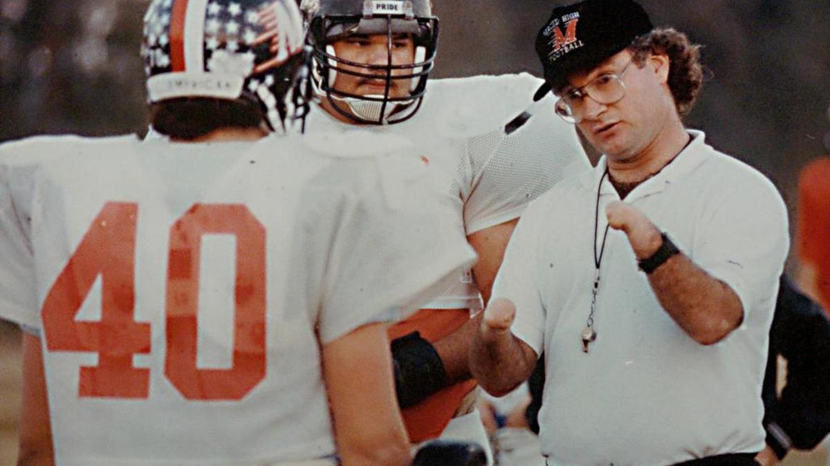 
Coach Mark Speckman talks with his players Dec. 5, 1989, at Merced High School.
