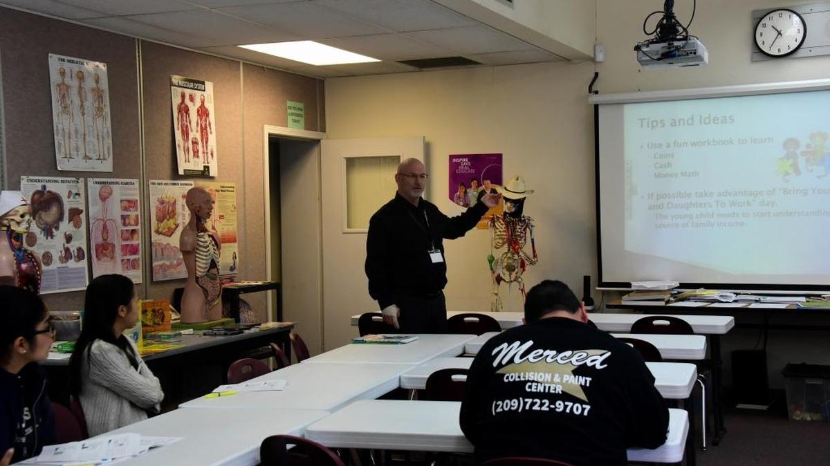 Mike Jones from Educational Employees Credit Union gives a presentation to parents about how to teach their children about money during the Parent Institute “Dream Big” conference at Golden Valley High School in Merced on Saturday, Feb. 25, 2017.