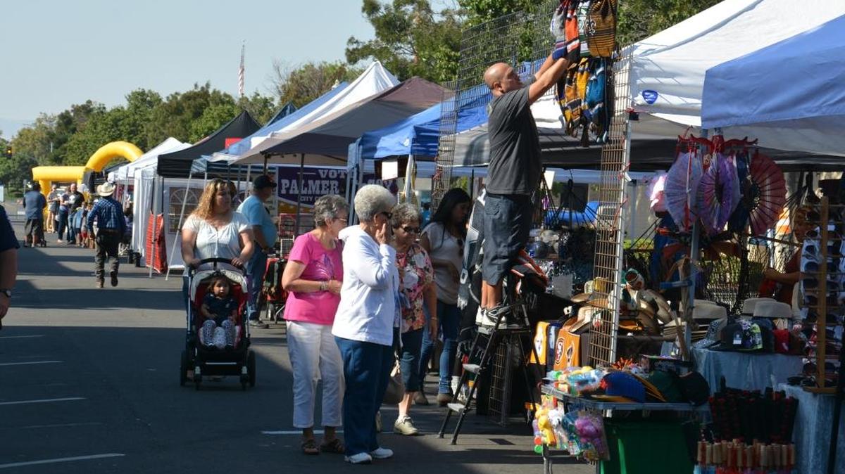 People browse some of the 60 vendor booths set up during the Fall Street Faire Saturday, Sept. 10, 2016, in downtown Los Banos.