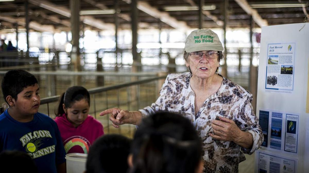 Jean Okuye of the East Merced Resource Conservation District, teaches children about soil during the annual FARM2U Day presented by the Merced County Farm Bureau at the Merced County Fairgrounds in Merced, Calif., Thursday, Oct. 8, 2015. The event is held to educate area students about how their food is produced in Merced County.