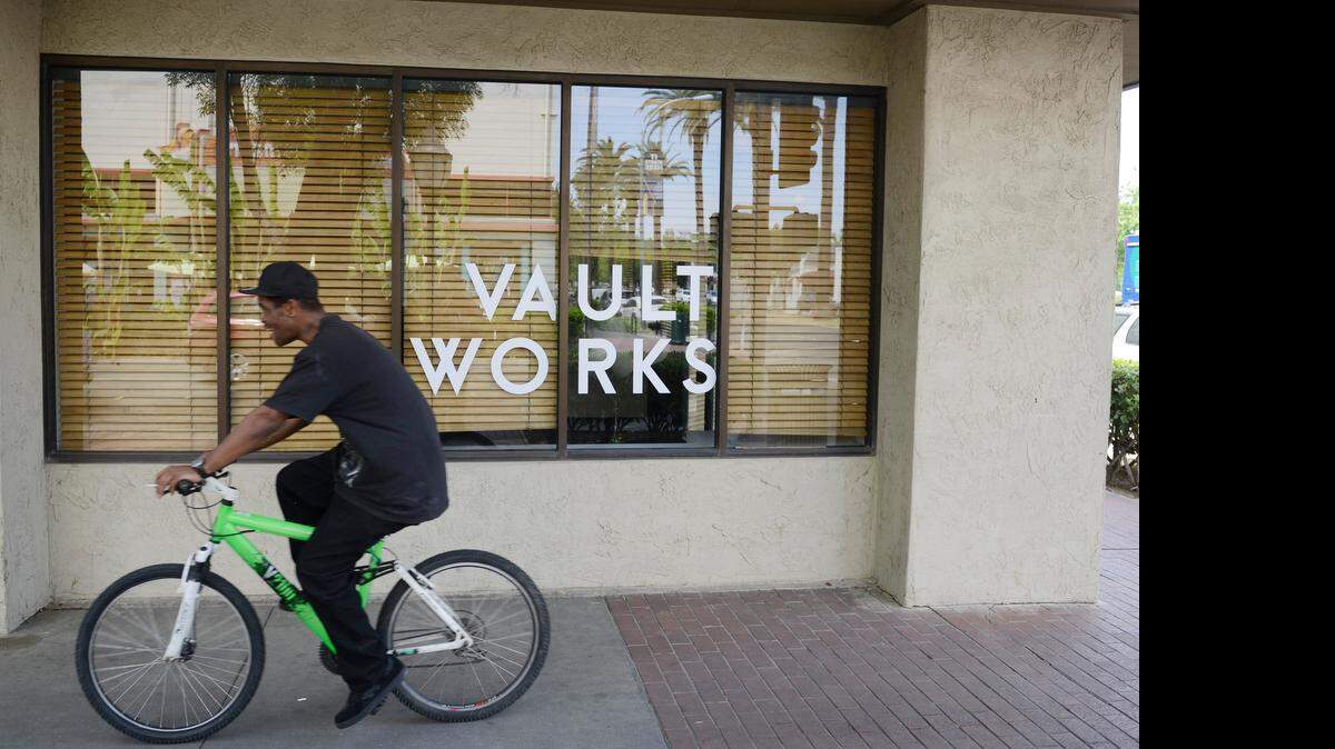 
A cyclist passes Vault Works, a new shared office space at 1666 N St. in Merced on Friday. The former Westamerica Bank building will house several startup businesses after renovations are complete.
