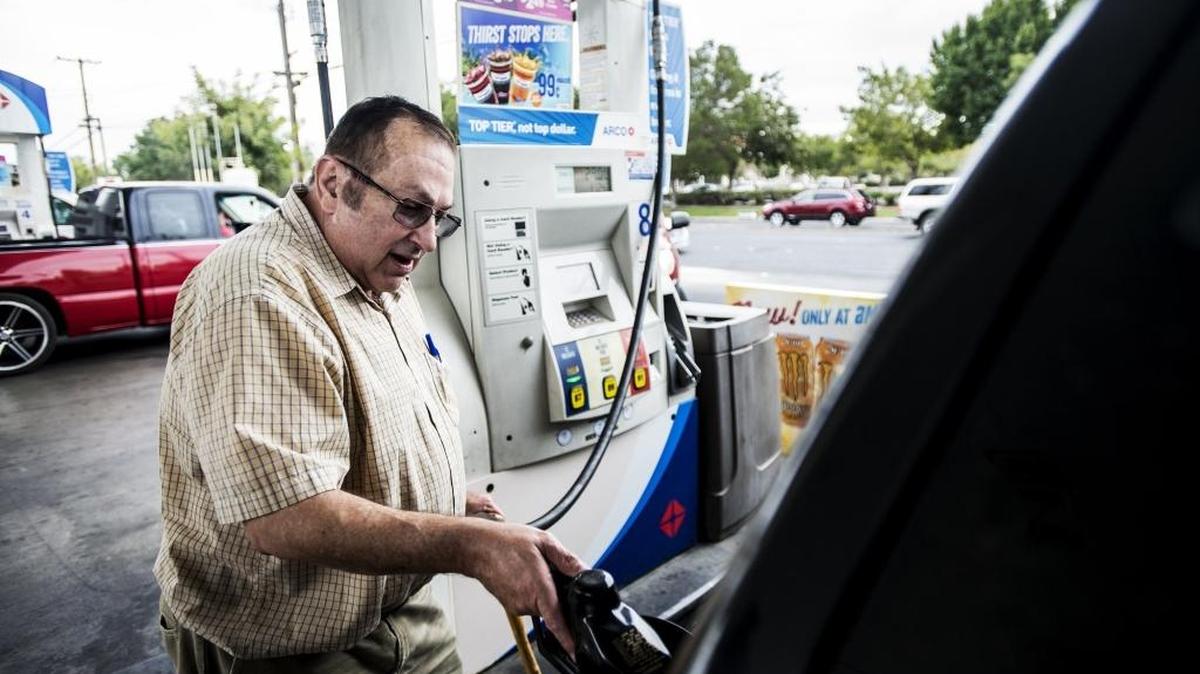 
Jack Wooten fills up his tank Monday at the Arco gas station at 3100 G St. in Merced, where prices were as much as 40 cents below the state average. 
