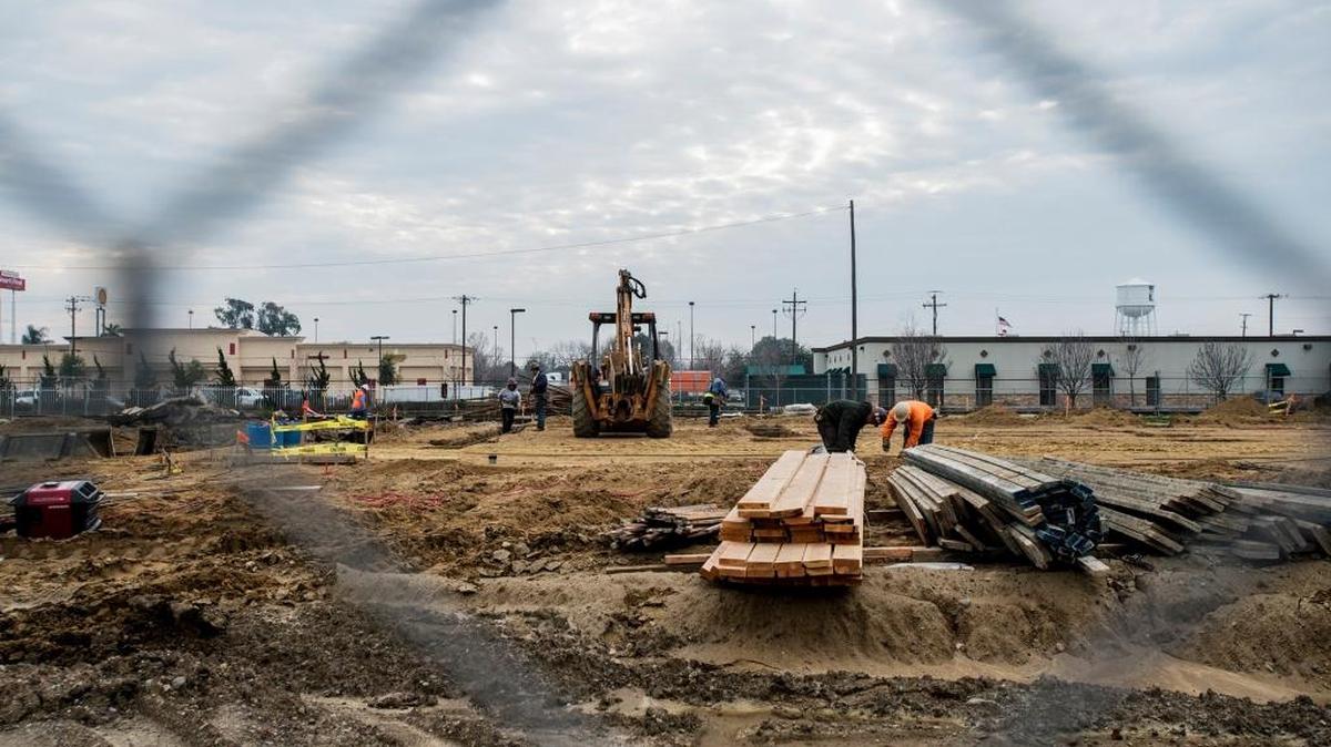 Construction crews work on a site designated for a Les Schwab Tire Center near West 16th and K streets in Merced on Friday, Jan. 29, 2016.