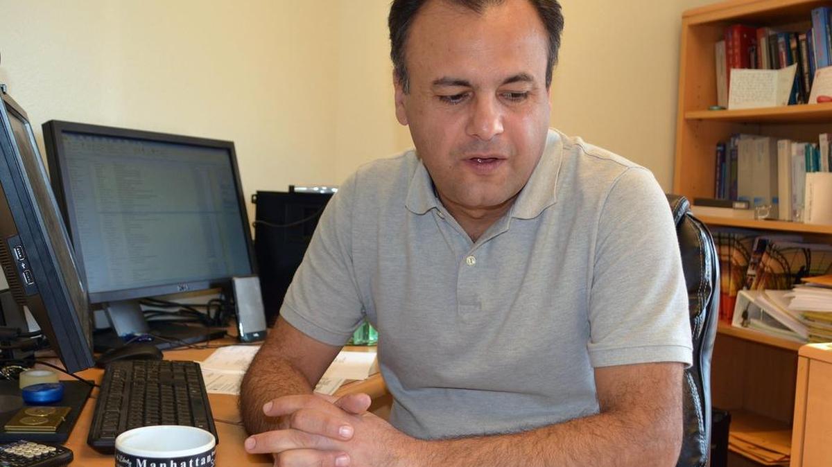 Stanislaus State professor Gökce Soydemir discusses his business forecast report on the San Joaquin Valley in his office on the Turlock campus, Nov. 4, 2015.