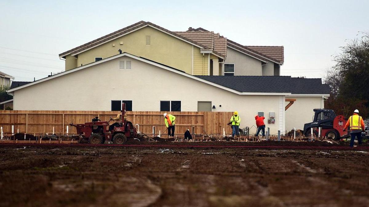 Construction crews work on houses going up in a subdivision near Yosemite Avenue and Via Moraga on Friday, Dec. 14, 2018.