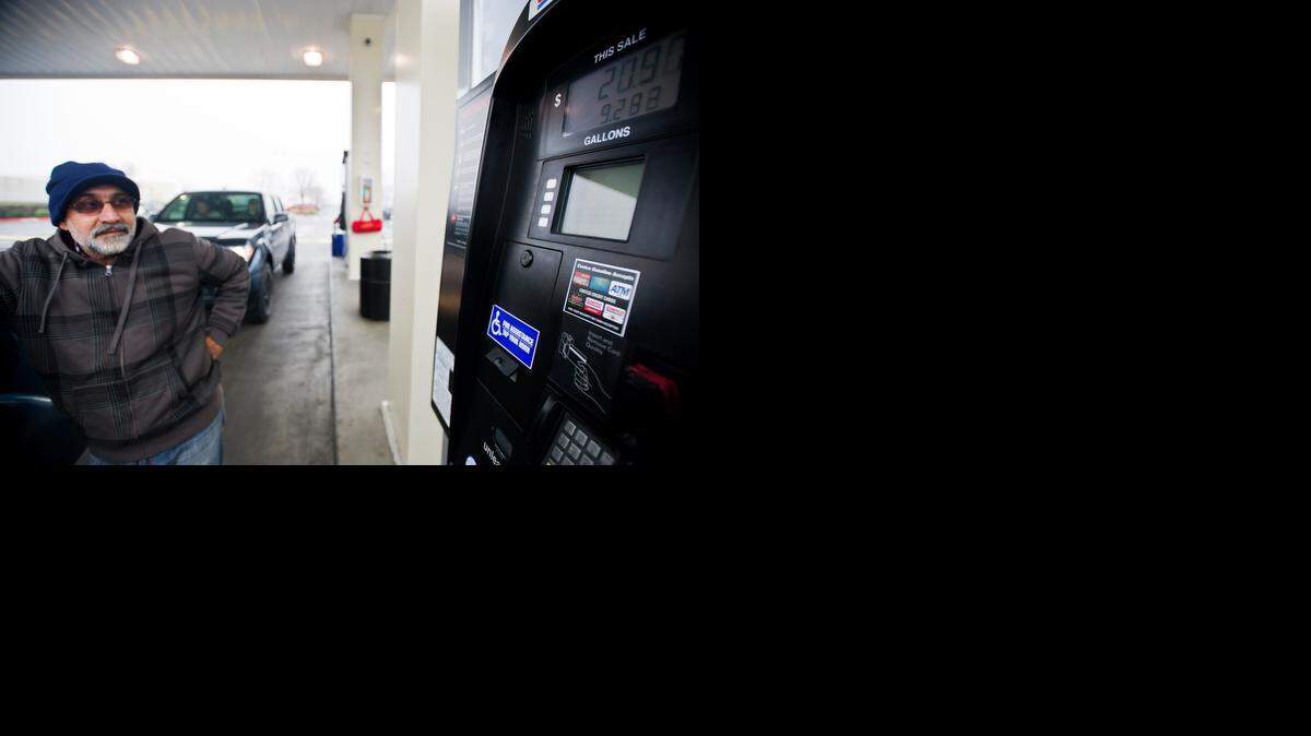 
Dalvir Chahal, 54, of Livingston watches the numbers on the gas pump as he fills his tank at Costco in Merced.

