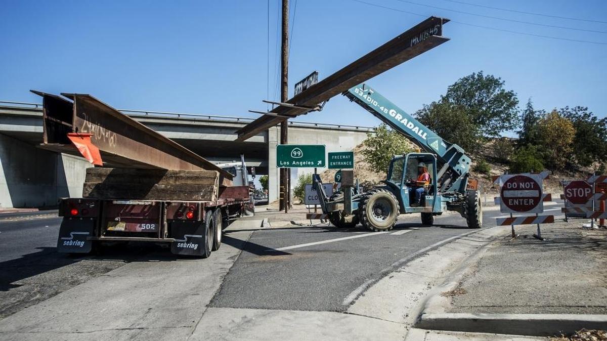 
Randy Lindsay of RGW Construction Inc., loads a large steal beam onto a truck at the closed southbound Highway 99 on-ramp at G Street, as road work continues along southbound Highway 99 in Merced, Calif., Tuesday, Sept. 1, 2015. According to the California Department of Transportation, the ramp is expected to open in the spring of 2016.

