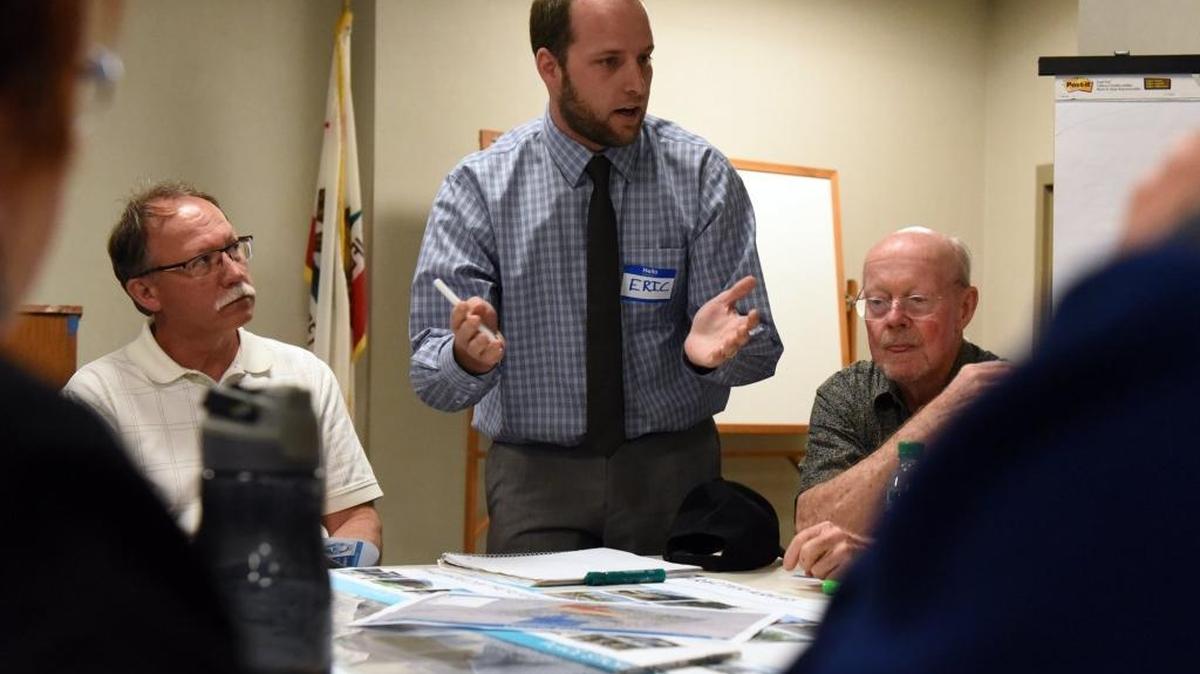 Eric Banghart, a transportation planner with Hatch Mott MacDonald, speaks with Merced residents about places near the proposed high-speed rail stop in Merced during a rail workshop at City Hall on Wednesday, Feb. 24, 2016. Many residents expressed an interest in balancing Merced's small-town feel with a more metropolitan city.