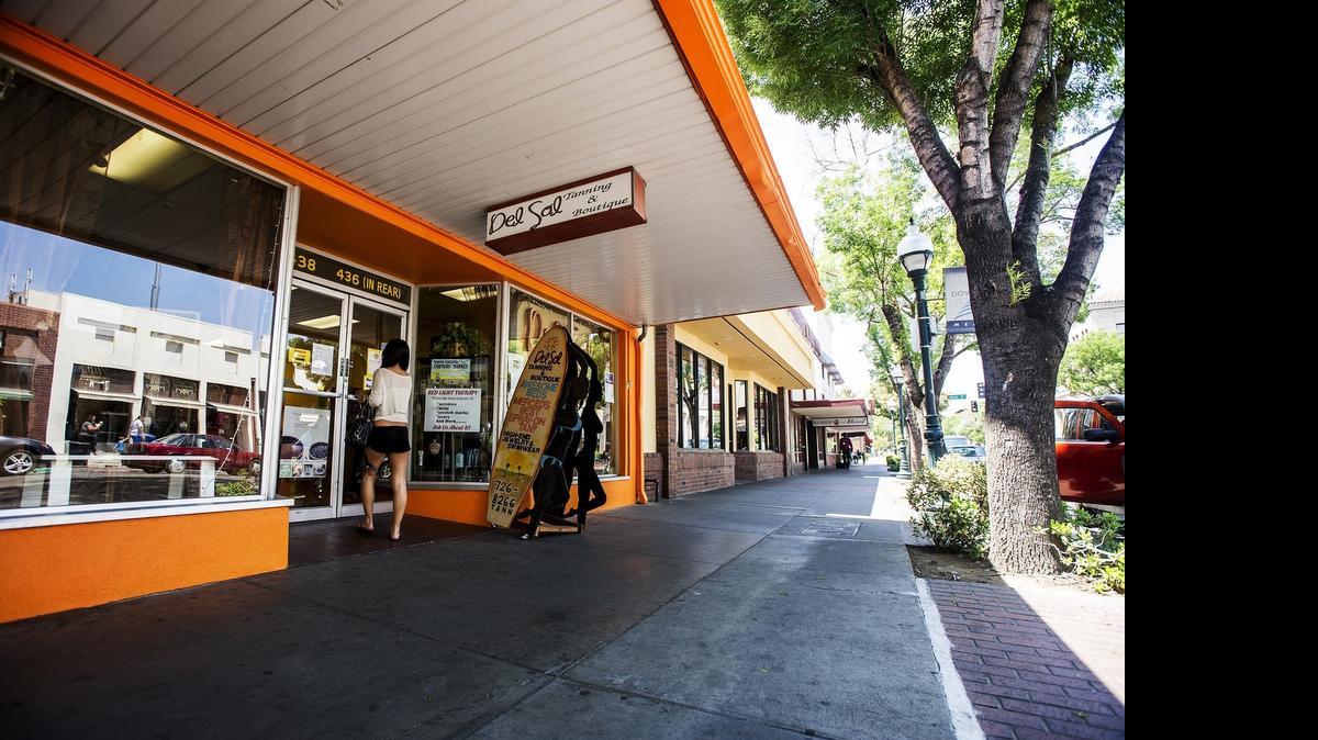 
A woman walks into Del Sol Tanning and Boutique on Main Street in Merced on Friday. For three years, Merced County has led the San Joaquin Valley in employment growth.

