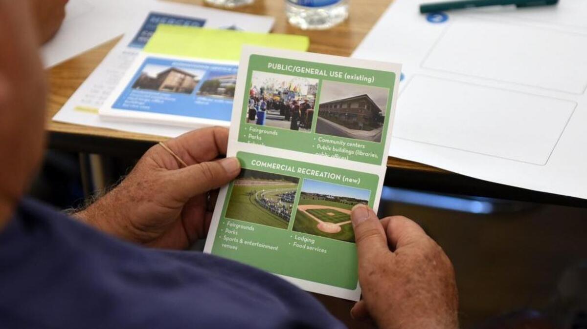 A resident looks at cards with different land uses Tuesday, June 28, 2016, at the Merced Senior Community center during a planning workshop on the future high-speed rail stop in town.