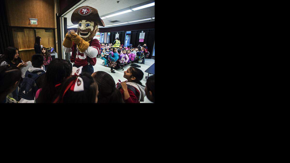 
San Francisco 49ers mascot Sourdough Sam signs autographs for students during breakfast Tuesday at Alicia Reyes Elementary School in Merced. The mascot’s visit was part of an event to promote National School Breakfast Week.
