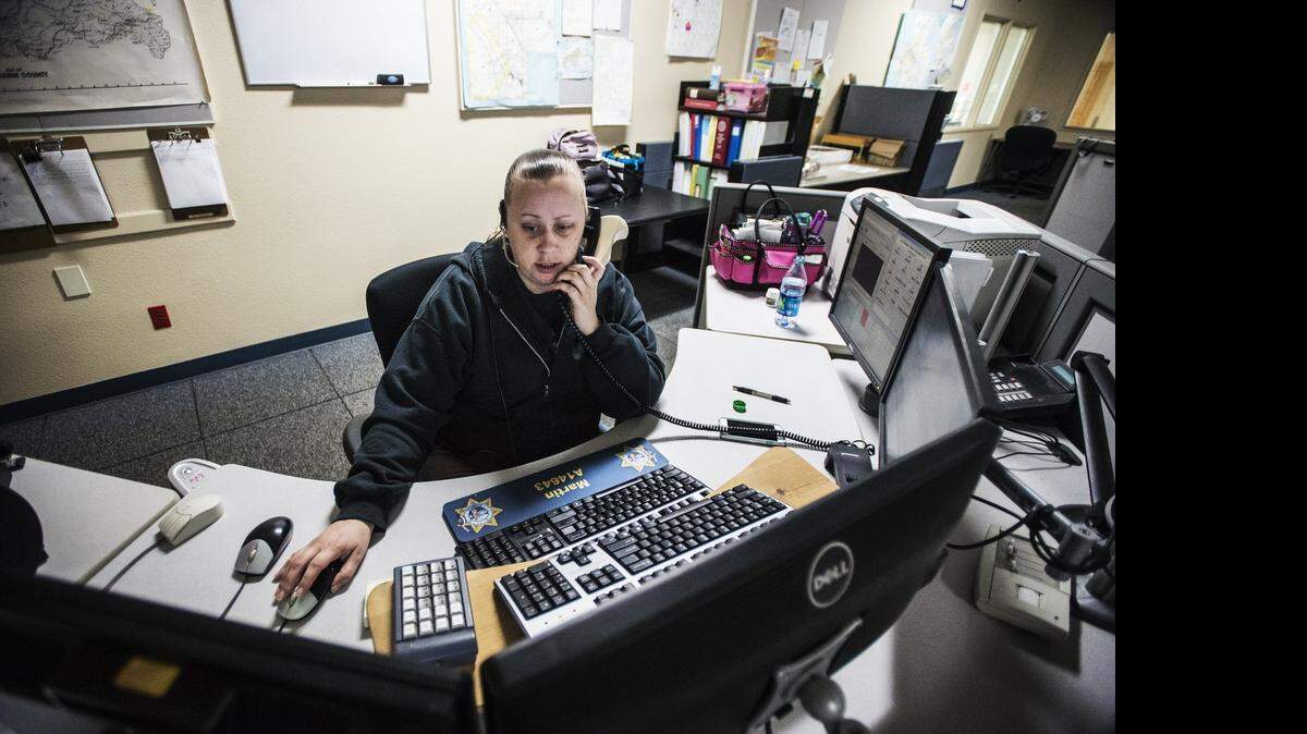 
Public safety dispatcher Nicole Martin, 33, of Atwater, answers a 911 phone call at the Merced-area California Highway Patrol office in Atwater on Friday. According to dispatch supervisor Keri Pickett, the office receives an average of 35,000 phone calls per month.
