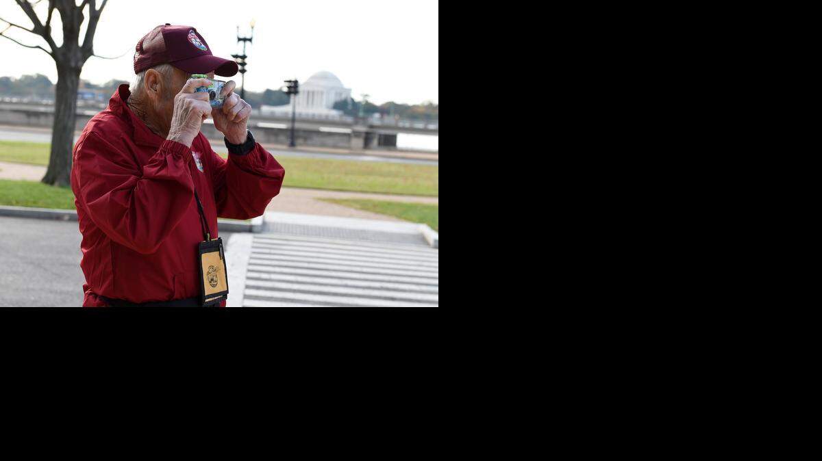 
WWII veteran Leonard Marsh of Merced County takes a photo while visiting the National World War II Memorial in Washington, D.C., on Oct. 28, 2014.
