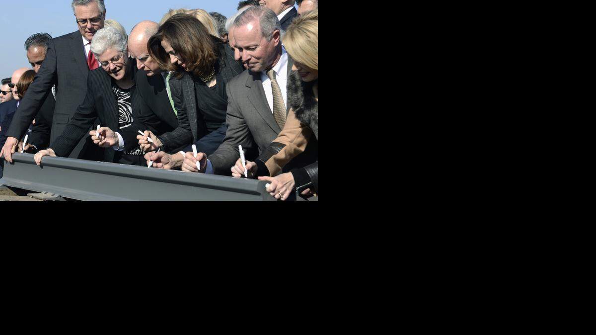 
Gov. Jerry Brown, center, signs a section of rail, flanked by his wife, Anne Gust Brown, center right, and Gina McCarthy, administrator for the EPA, center left, and other dignitaries at the groundbreaking ceremony for the state’s high-speed rail project Tuesday afternoon in Fresno.
