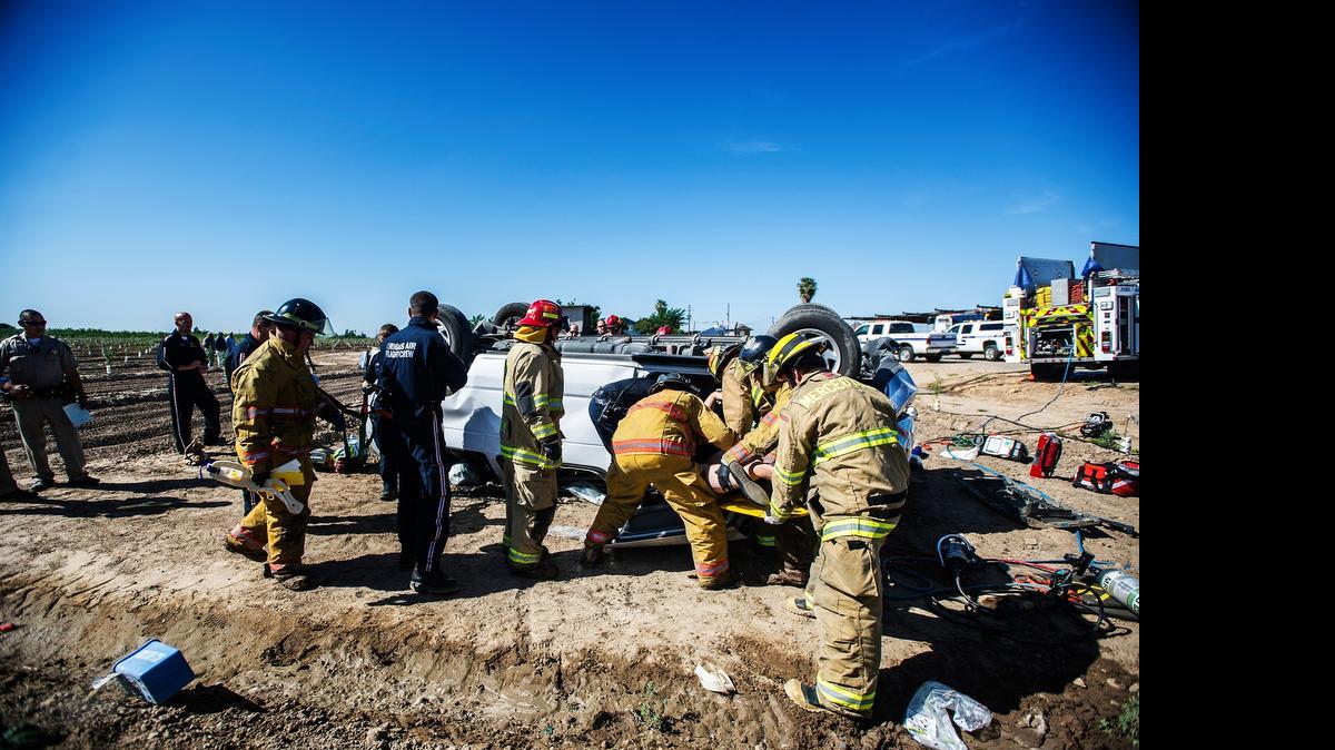 
Rescue crews remove a woman from a vehicle at the scene of a single vehicle rollover crash on Belcher Avenue near Beachwood Drive in Merced on Wednesday, April 29. According to California Highway Patrol Sgt. S. McConnell, one male and two female passengers were transported to regional hospitals.
