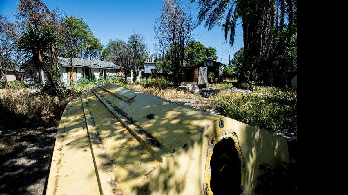
Trash and overgrown weeds surround a house covered in graffiti in the 1800 block of East 22nd Street in Merced on Wednesday. According to Merced County, dry weeds taller than 18 inches in height pose a fire threat and are subject to abatement.
