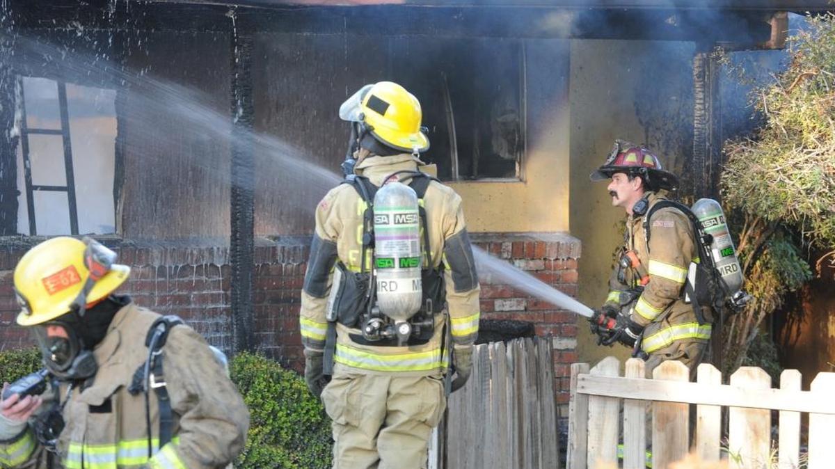 Los Banos and Merced County firefighters extinguish a house fire last December on Pioneer Road just outside the Los Banos city limits.