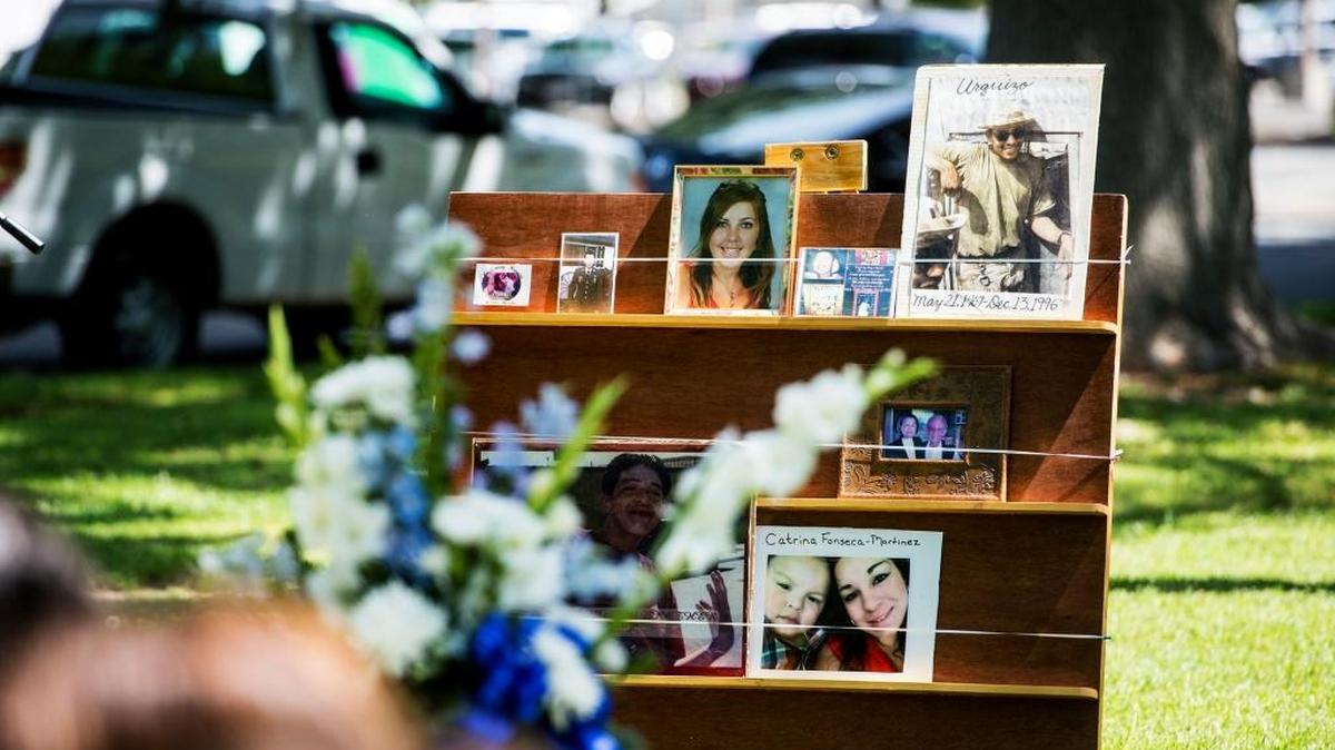Photographs of murder victims are displayed during a victims' rights ceremony at Courthouse Park in Merced Calif., Thursday, April 14, 2016.