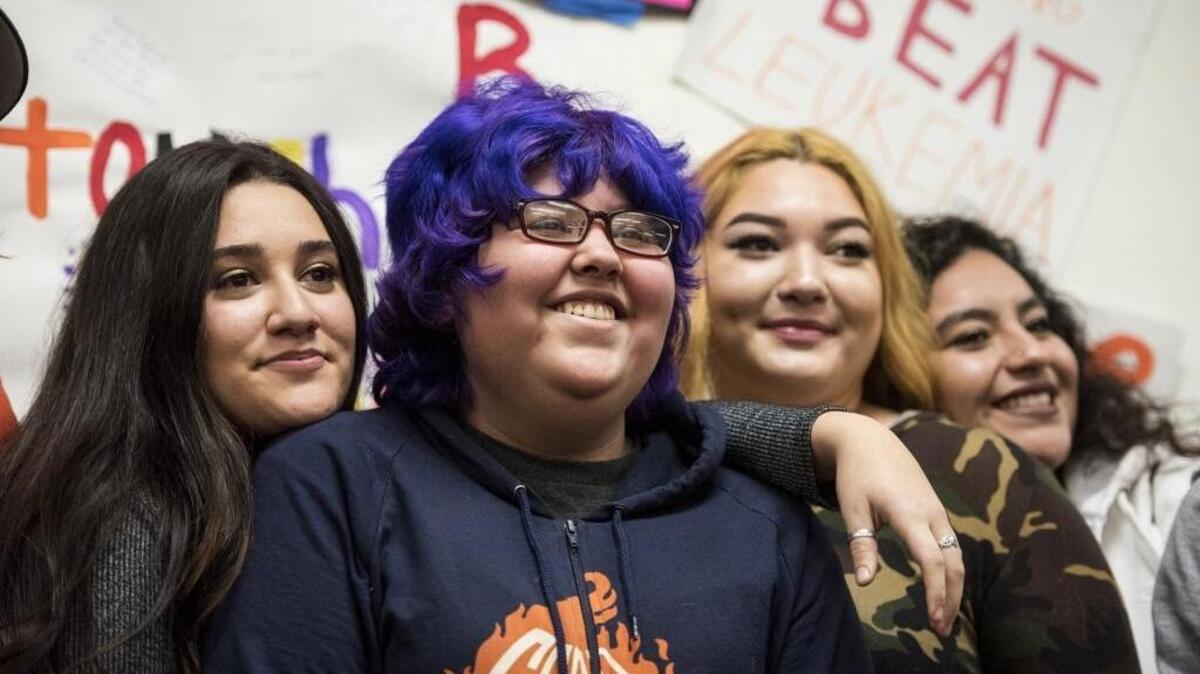 Mina Lopez, center, poses for photos with students at Yosemite High in Merced on Tuesday. Make-A-Wish Central California granted Lopez’s wish with a trip to meet “Weird Al” Yankovic in San Francisco.