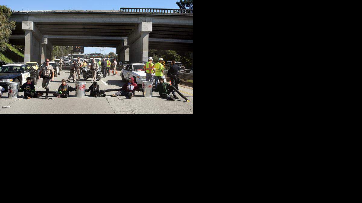 
Students at the University of California, Santa Cruz, block traffic to protest proposed tuition hikes on Tuesday.
