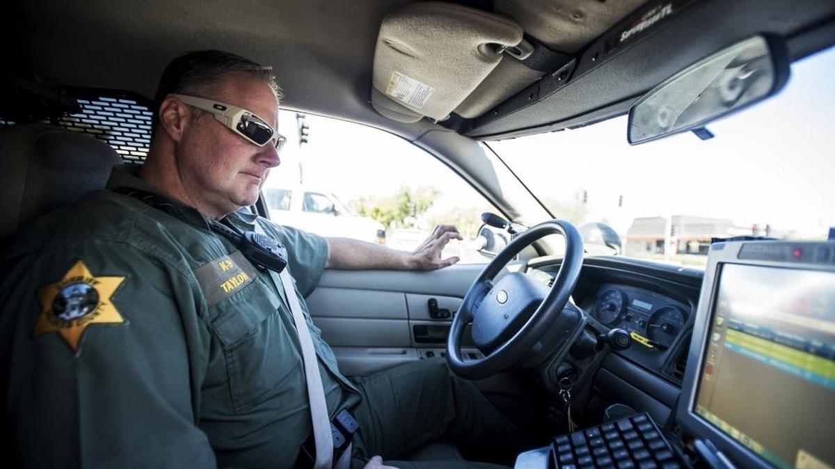 
Merced County Sheriff’s Deputy Mark Taylor, 47, glances at his computer while on patrol Monday. According to Sheriff Vern Warnke, the department currently has 22 vacancies.
