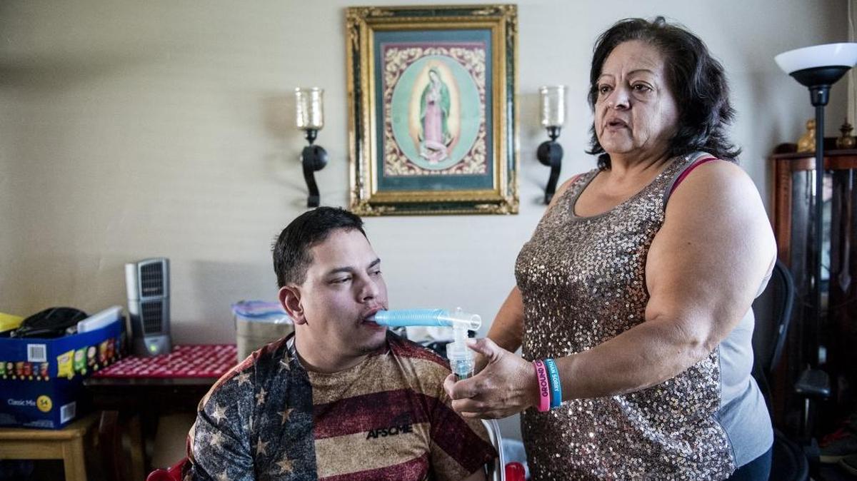Merced resident Susana Saldana, 56, speaks about taking care of her son Mario Resendez, 29, while giving him his daily medicine used in a nebulizer at their home in Merced, Calif., on Wednesday, Sept. 14, 2016.