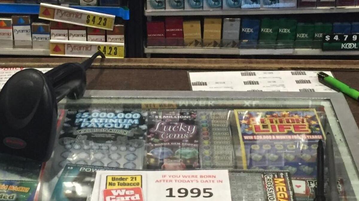 A sign shows the new age limit to buy tobacco in the shop Cigarettes and Cigars on G Street on June 8, 2016.