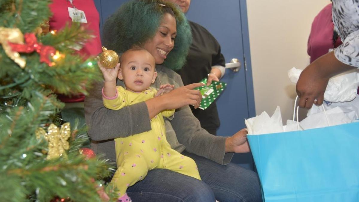 Shoquala Reed, 21, and her 1-year-old daughter, Cerina Reed-Regalad, are seen at the Golden Valley Health Centers Women’s Clinic on Wednesday. Every year Golden Valley chooses a family to ‘adopt’ during Christmas and the staff bring in gifts and contributions for the family.