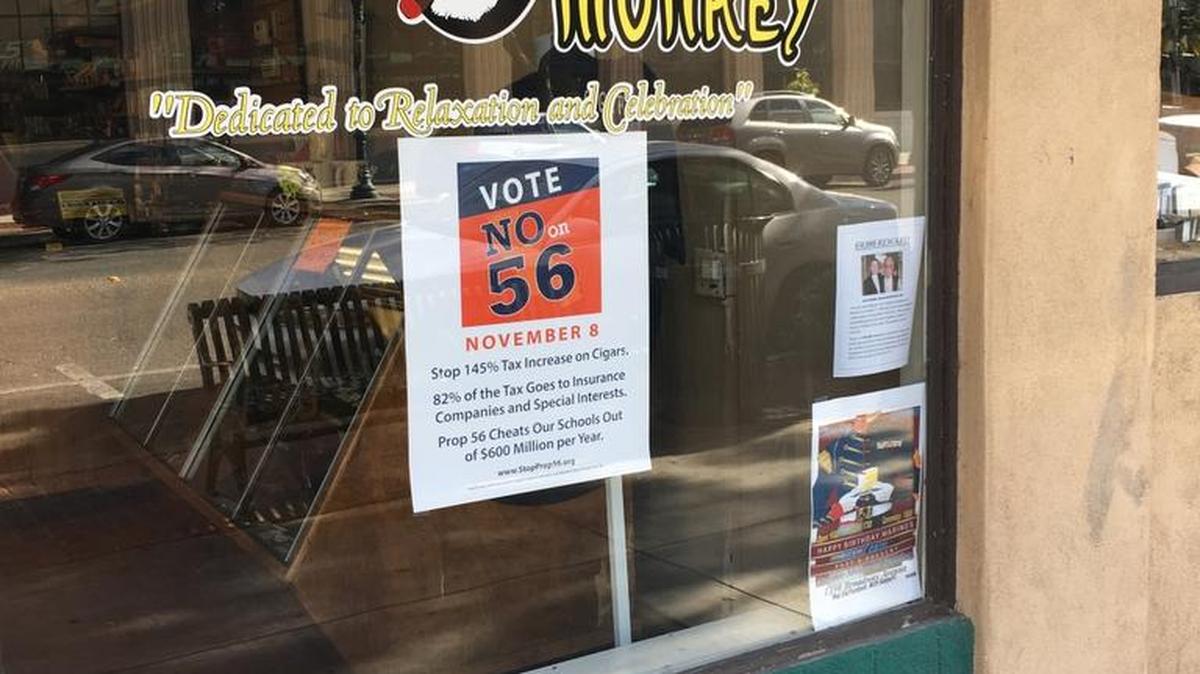 The front of a premium tobacco shop on Canal Street in Merced, Cigar Monkey, on Nov. 1, 2016, with a “ Vote No On Prop 56” sign.