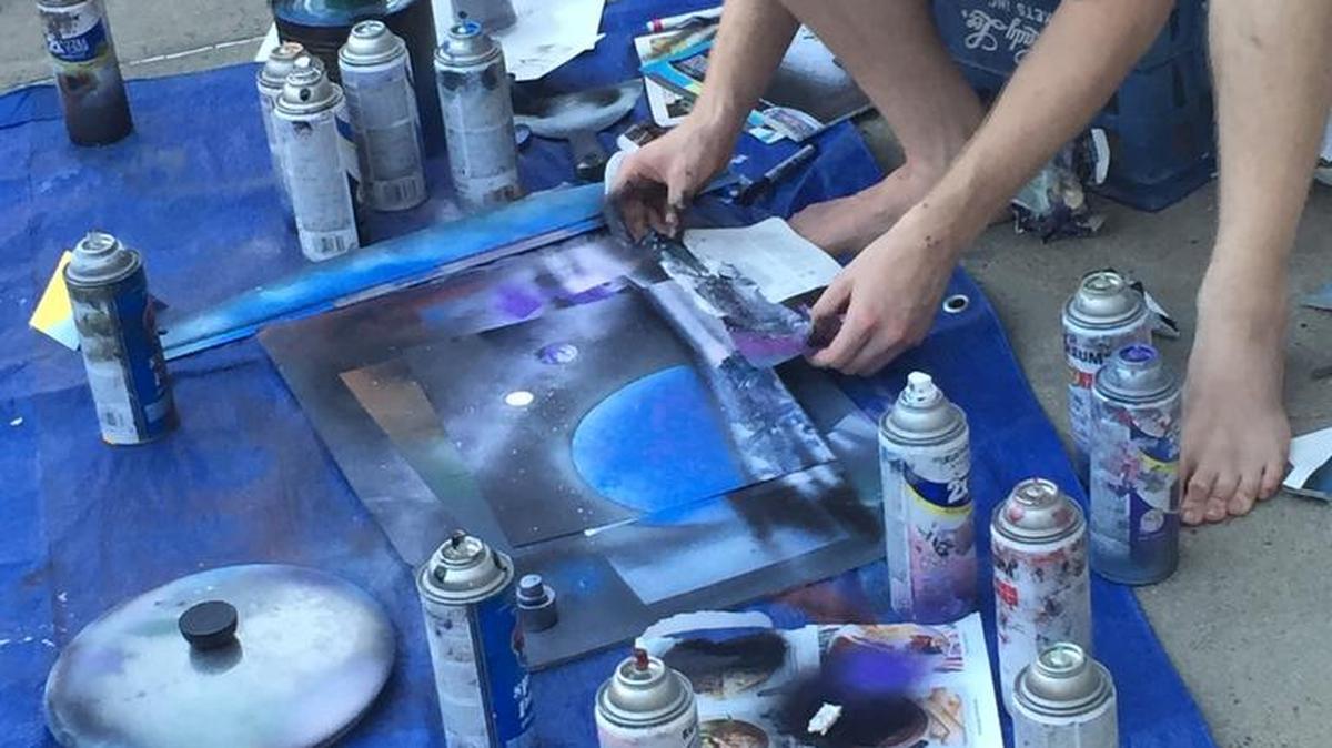 Awtater resident Andrew Gray, 23, makes spray paint art on Saturday, July 16, 2016, at Art Hop in downtown Merced.