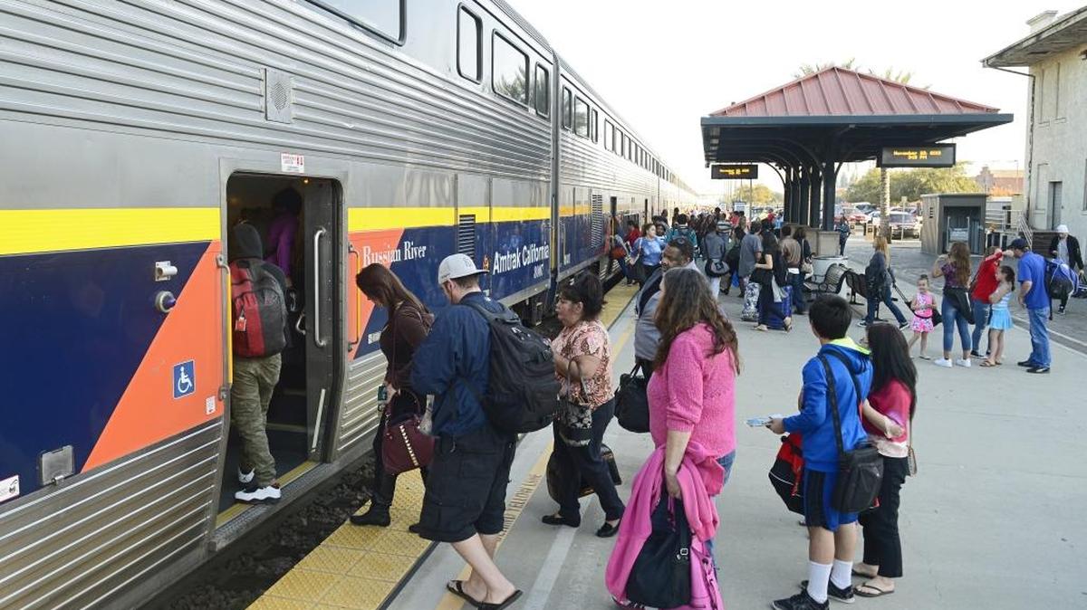 Travelers begin boarding an Amtrak train in Fresno during the 2015 holiday season. Amtrak officials say they expect high passenger demand this year and advise would-be train travelers to buy their tickets ahead of time and to arrive at the stations early.
