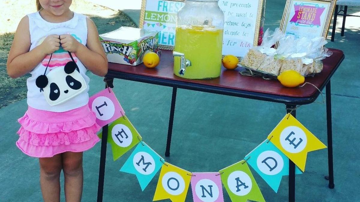 Kadence Stephens, 6, standing in front of the lemonade stand she had in front of her home in Atwater. She raised $260 that she used to buy toys she donated to Toys for Tots, an organization who gives presents to children in need for Christmas.