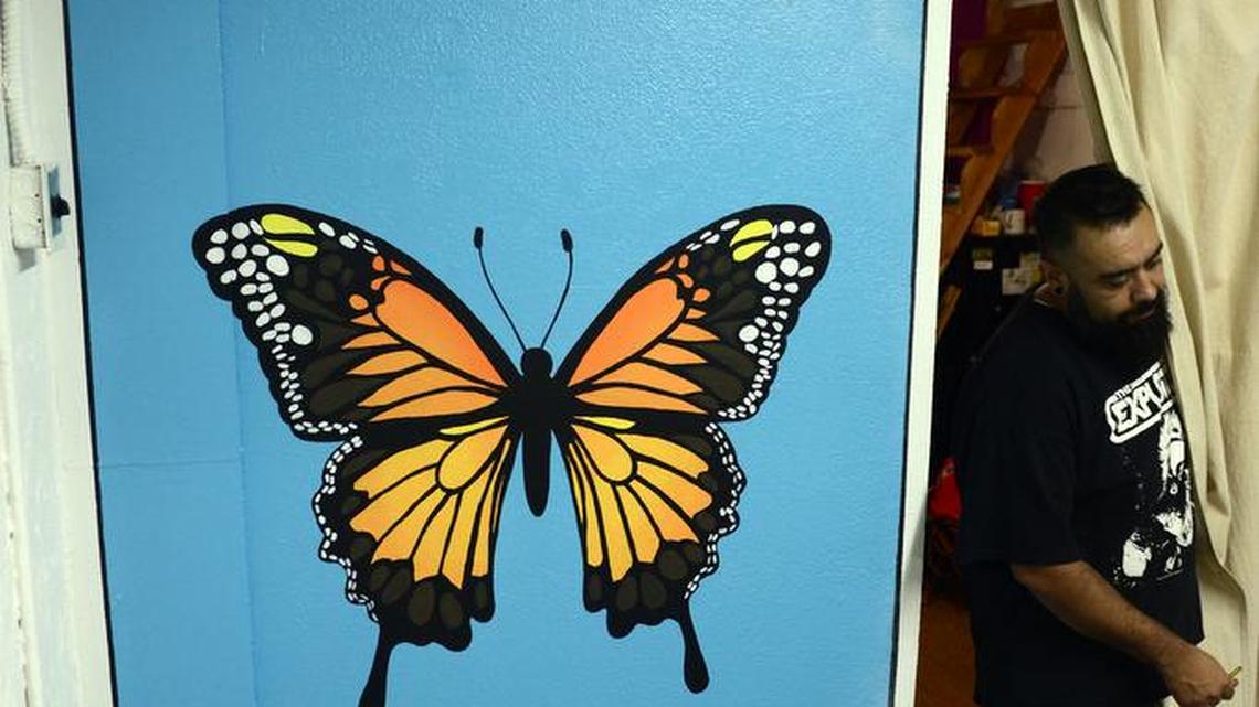 
Ramon Valencia, co-owner of the Mariposa Art Company, walks past a folk art piece inside the gallery in Merced on Thursday, Oct. 15, 2015..
