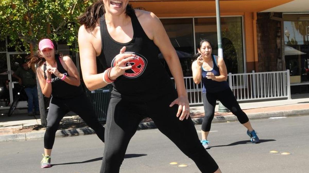 Angie Mendoza, Cindy Vega, and Meuy Saelee (left to right) demonstrate a R.I.P.P.E.D. fitness workout at the first Merced Healthy Living Festival on June 30, 2013.