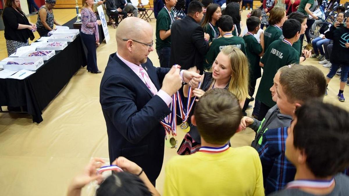 Ballico-Cressey School District Superintendent Bryan Ballenger hands out awards at Golden Valley High School on Thursday, March 10, 2016, to his seventh-grade students who won the Super Quiz prize at the 2016 Academic Pentathlon awards.