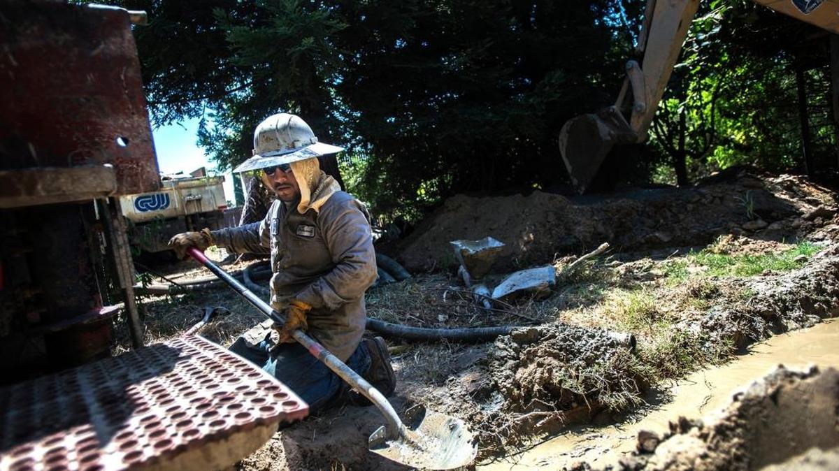 Sand is inspected by Calwater Drilling Co. employee Armando Blas, 36, of Atwater while drilling a well at a home on Belmira Road in Atwater in June.