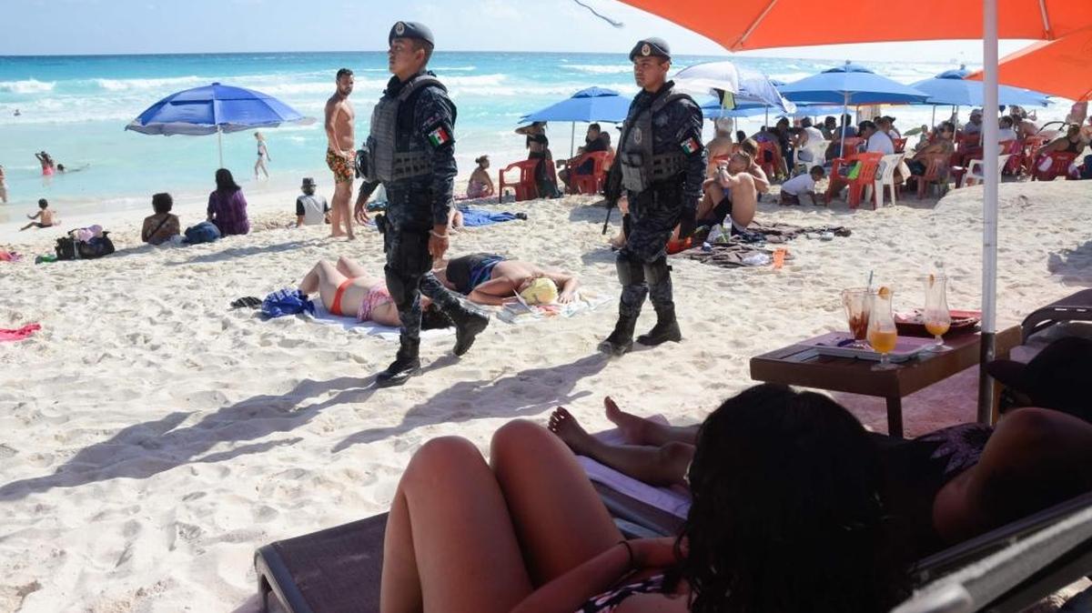 This file photo taken on January 18, 2017 shows Mexican Federal Police patrolling a beach in Cancun, Mexico, where a shooting occurred in a nightclub the day before. The US State Department on August 22, 2017, issued a travel advisory warning US citizens of travel to Cancun and Los Cabos due to increased violence.