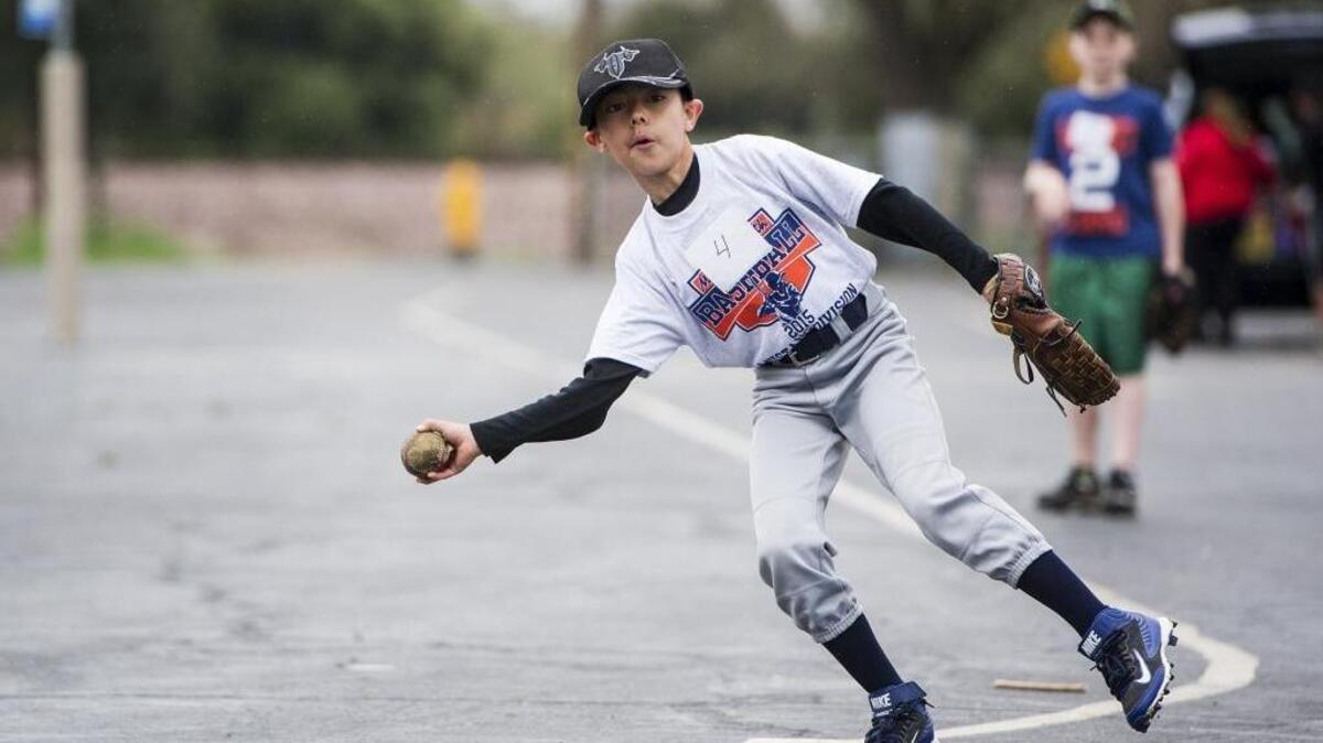 Young baseball players showcased their skills for coaches during player assessments at Hoover Middle School in Merced on Saturday, March 5, 2016. Above, Torin Olivarez-Kidwell, 10, of Merced makes a throw during a drill. According to Merced Youth Baseball Commissioner Paul Cortez, the league consists of 30 teams with players ranging in age from 4 to 14 years old. Players fielded grounders, caught pop-ups, and worked on bunting and covering bases.